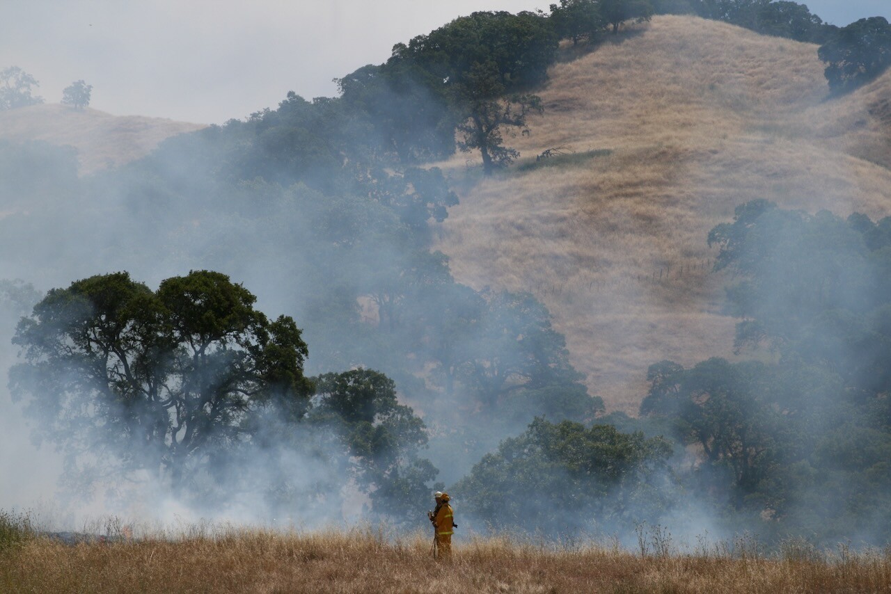 A firefighter monitors a prescribed burn at Blue Oak Ranch Reserve, San Jose, California. You do not restore a degraded landscape by refusing to enter it.
